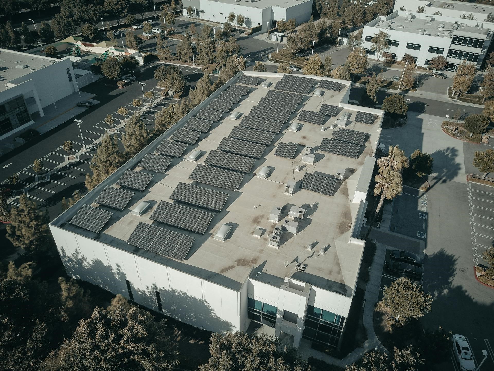 Alt=»Obligation de solarisation qui est concerné? Panneaux solaires sur le toit d'un bâtiment tertiaire.»